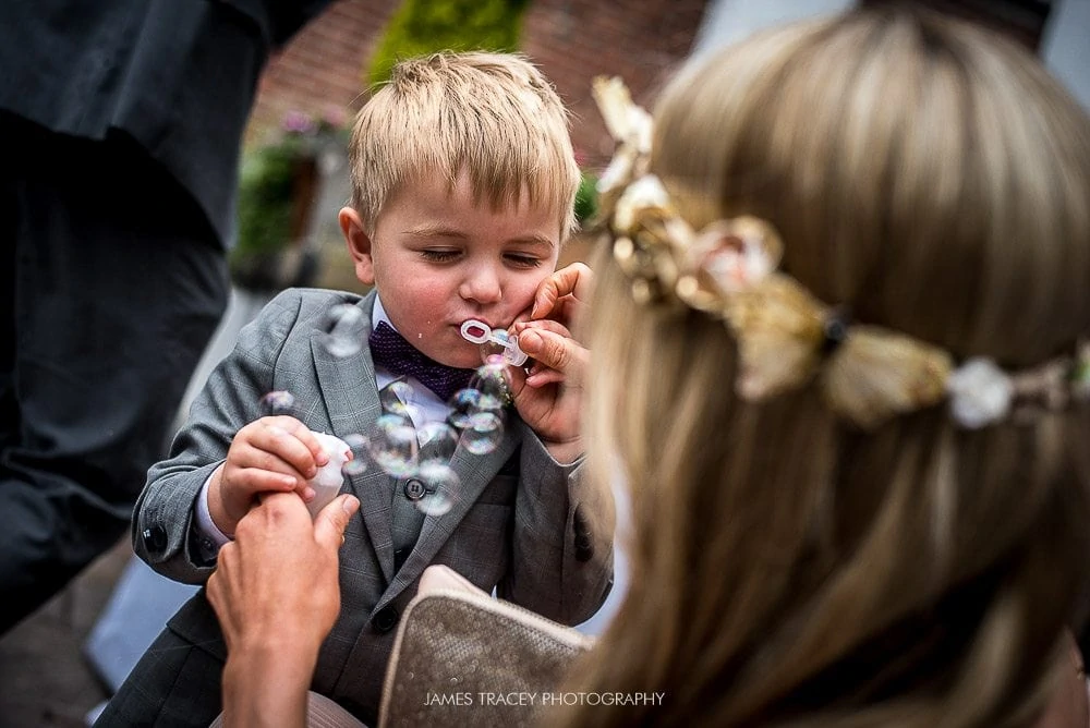 young boy blowing bubbles