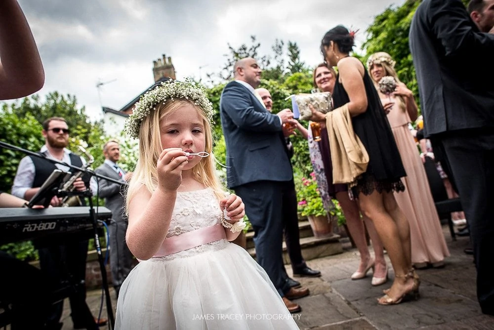 flower girl blowing bubbles