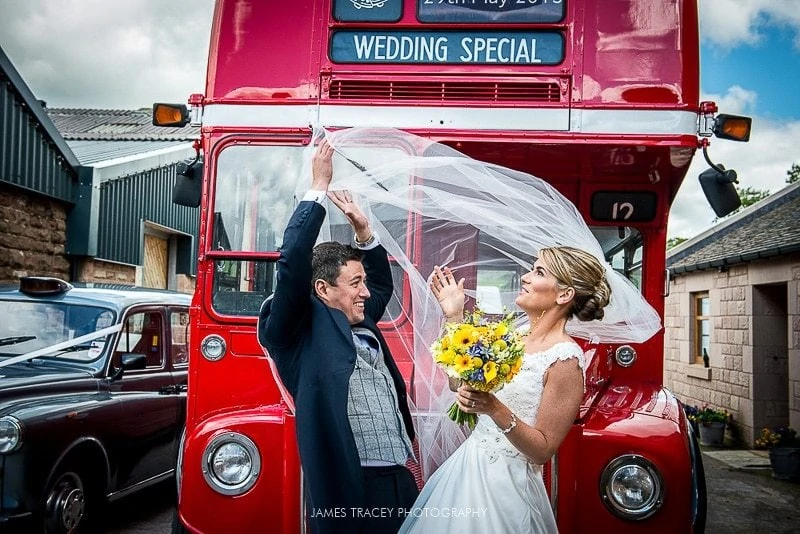 bride and groom at heaton house farm in front of a routemaster bus