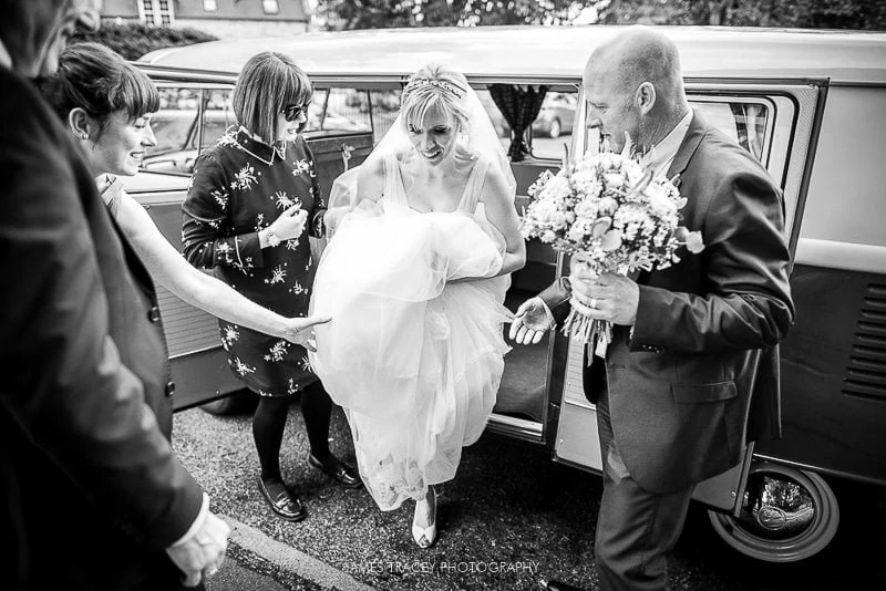 bride getting out of a camper van before her hathersage wedding