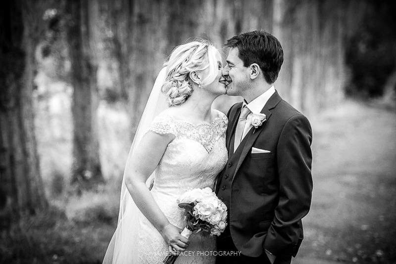bride and groom kissing in black and white