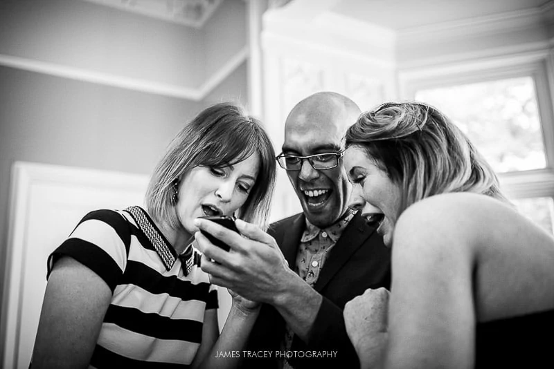 wedding guests looking at a smart phone