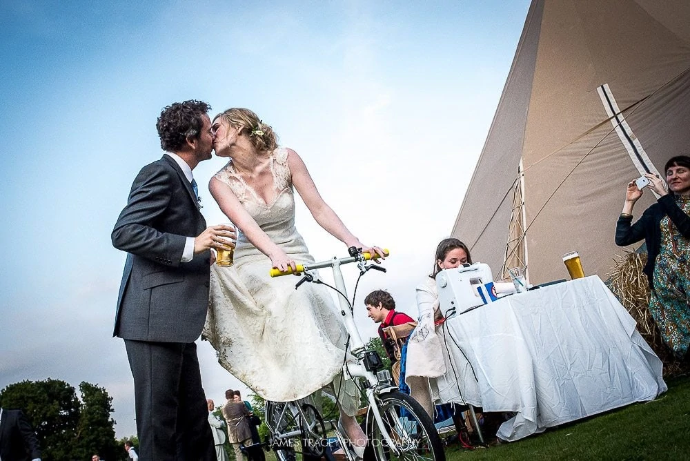 wedding couple kissing on a bike