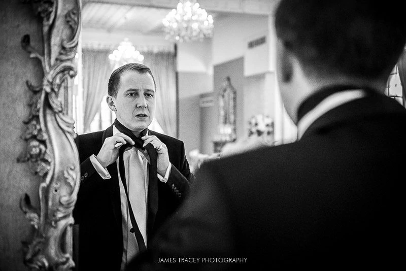 groom adjusting his tie