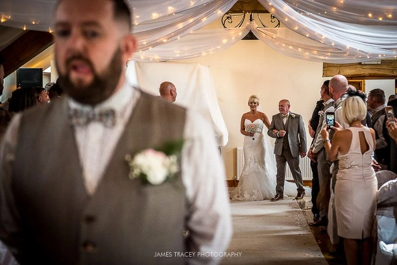 bride coming down the aisle at beeston manor