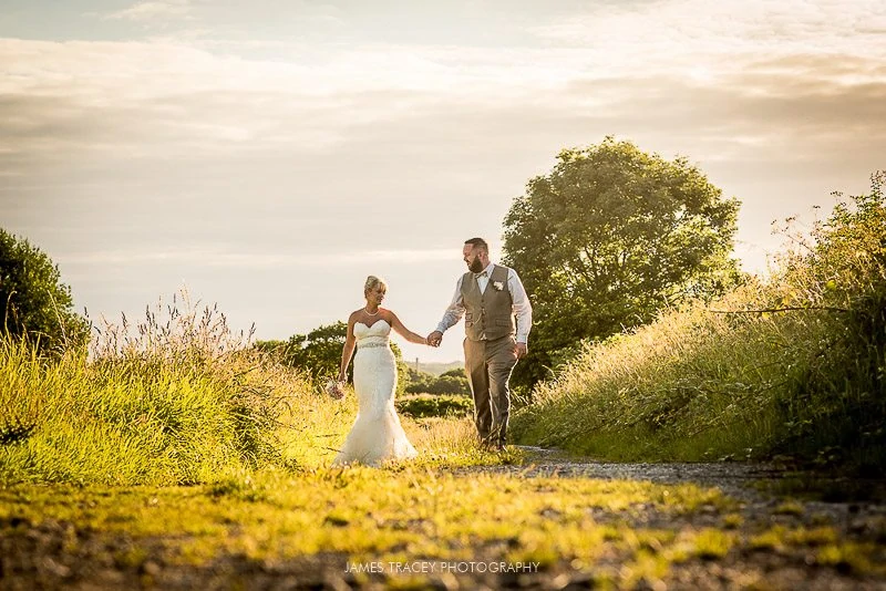 bride and groom walking in the sun