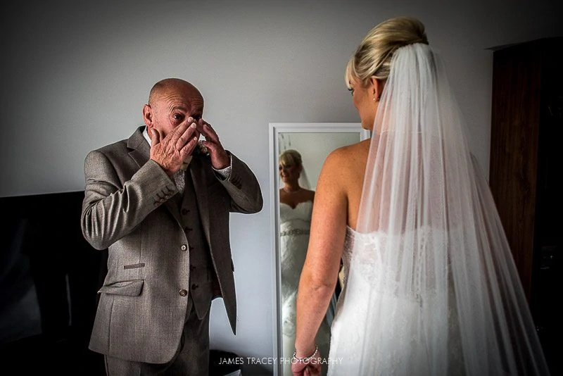 father of the bride wiping tears away