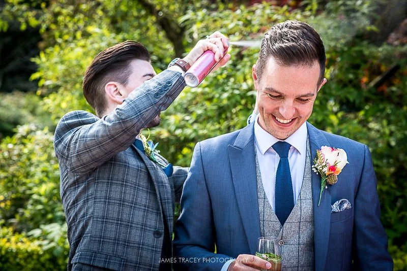 groom having his hair sprayed