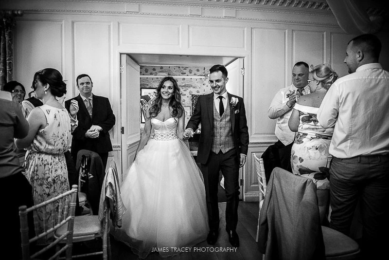 bride and groom walking into wedding breakfast