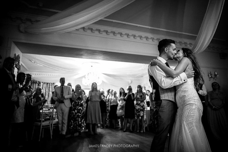 wedding couple kissing at eaves hall