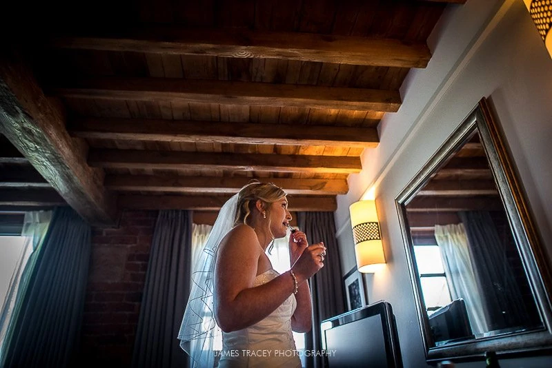 bride applying lipstick