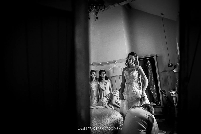 bride putting on her wedding dress