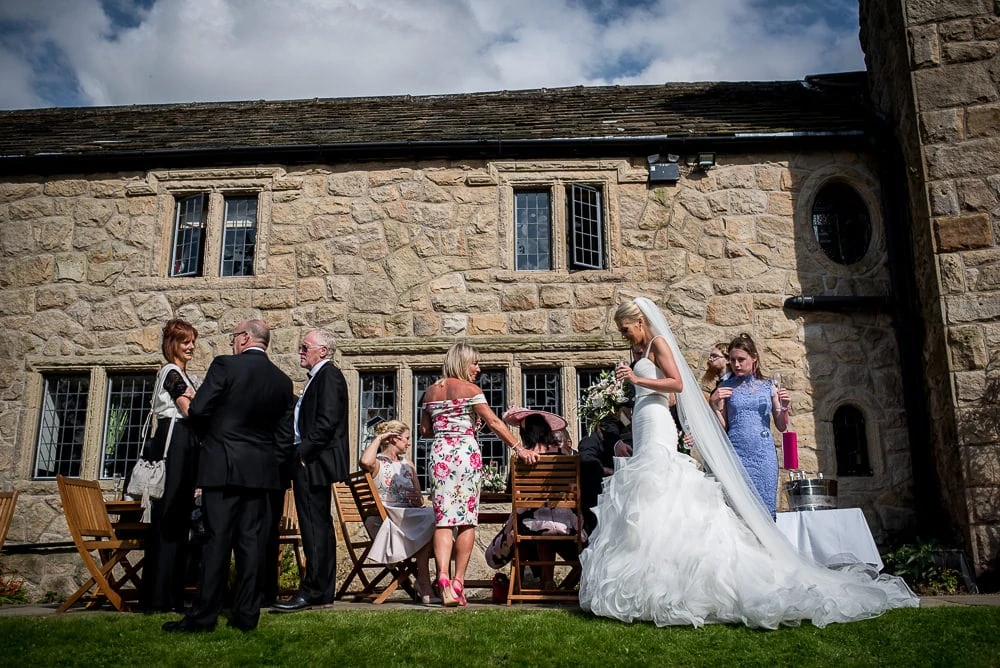bride chatting to wedding guests at upper house hayfield