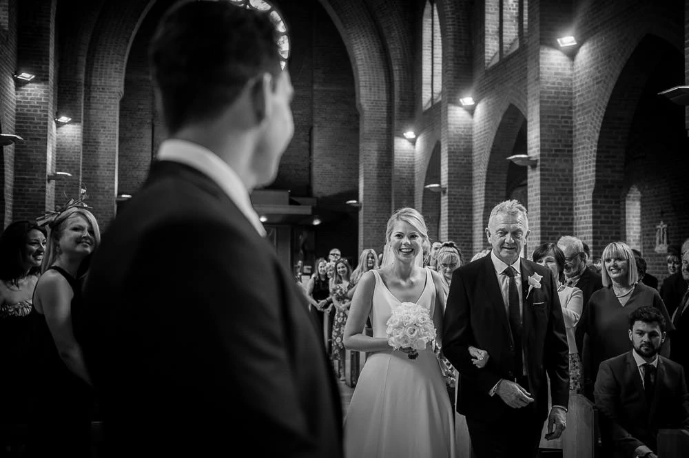 bride walking up the aisle in hale barns