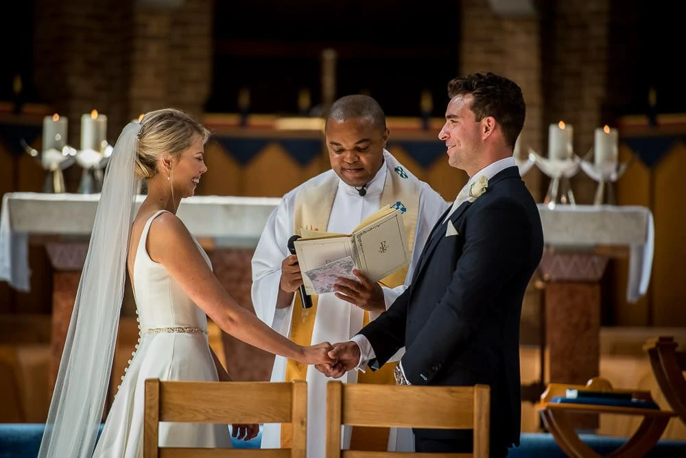bride and groom laughing in hale barns church