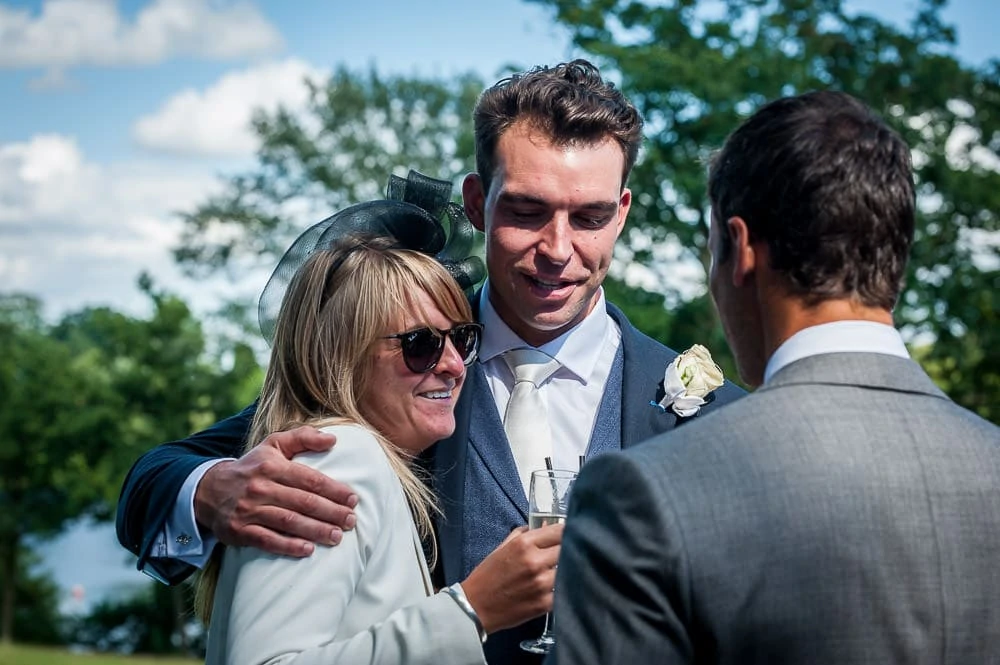 groom hugging a wedding guest