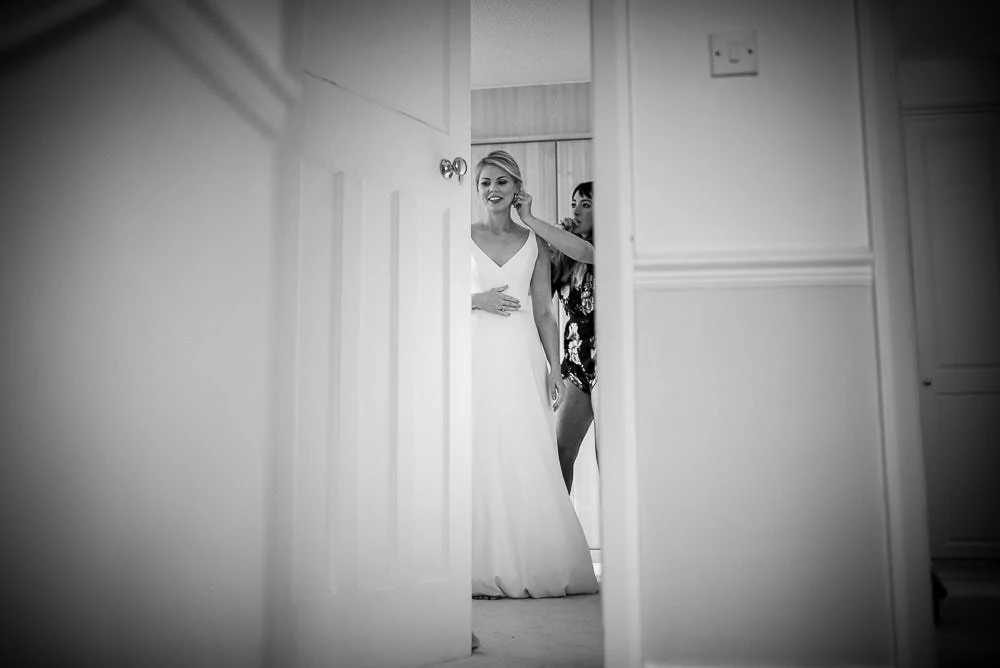 bride getting in her wedding dress