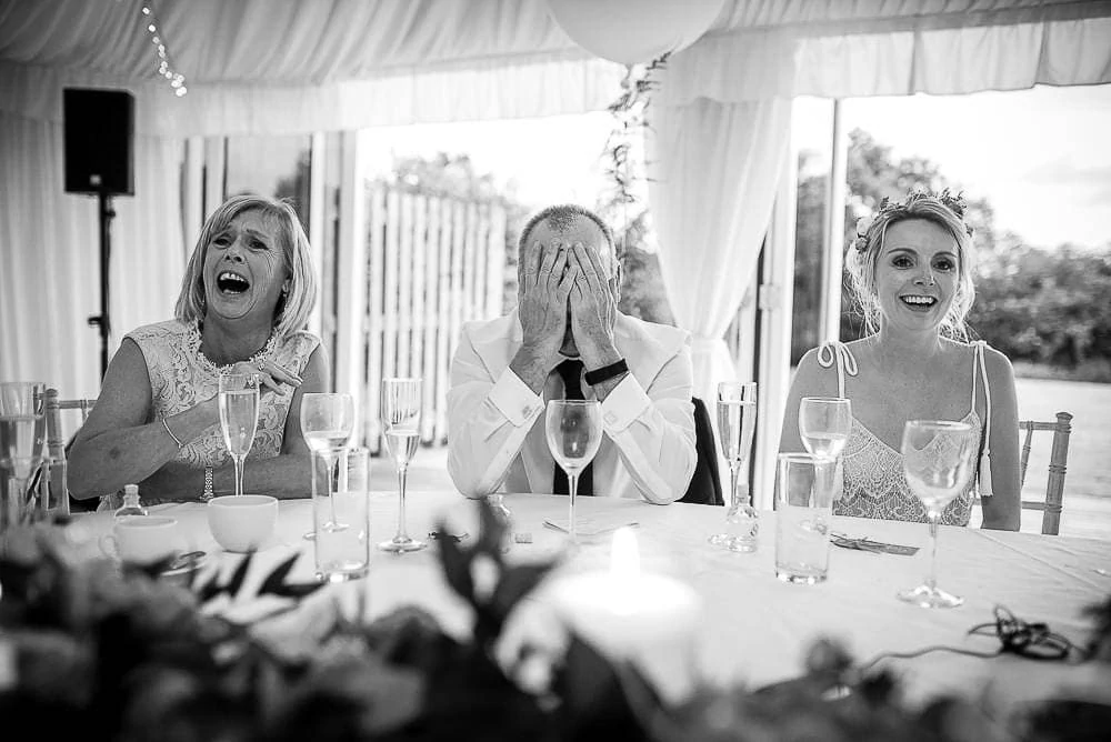 father of the bride with his head in his hands
