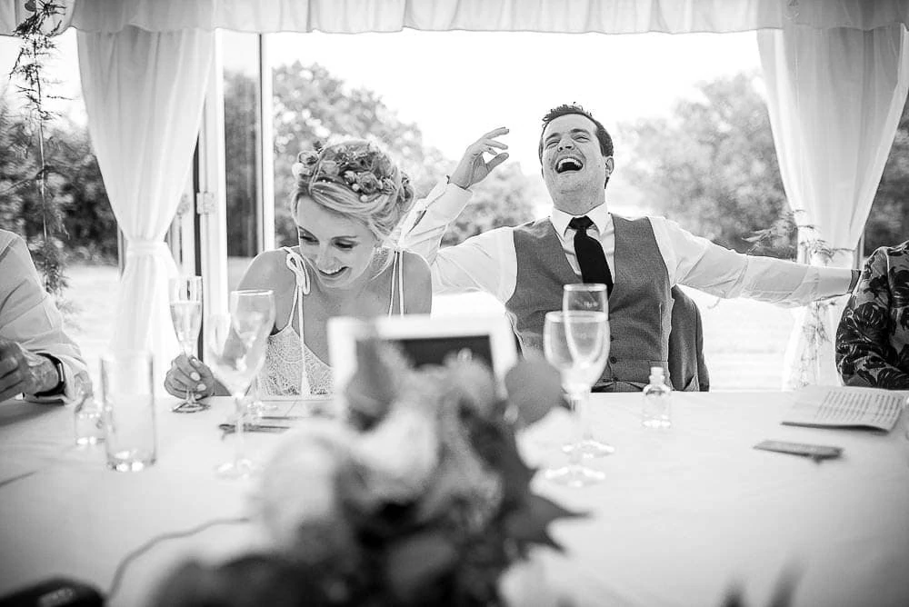 groom laughing at speeches