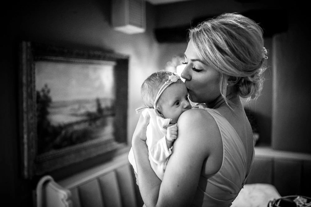 bridesmaid kissing baby