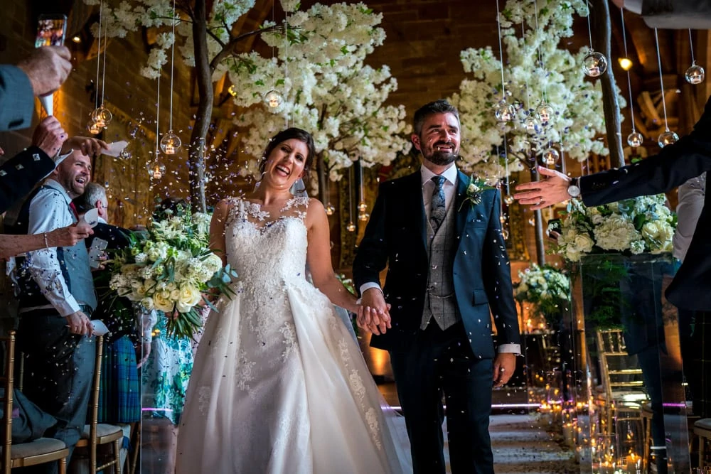bride and groom confetti in front of Kelly Louise Floral Artistry