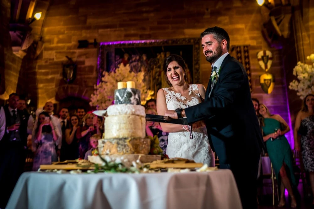 cake cut with sword at Peckforton Castle Wedding
