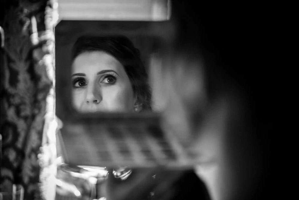 Relection of bride in mirror at Peckforton Castle