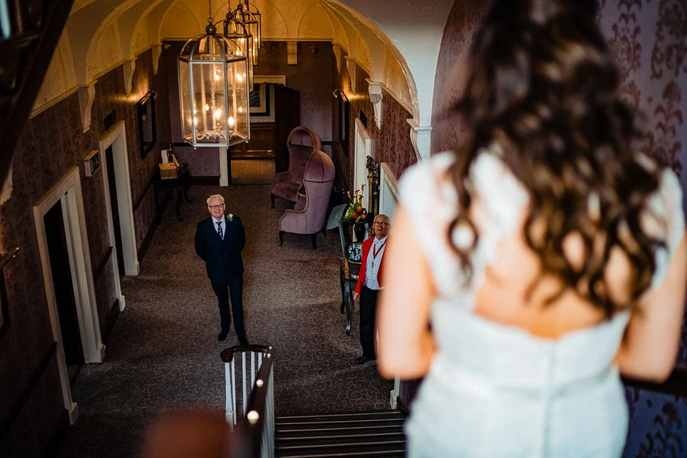 father of the bride seeing her for the first time at steps at mottram hall