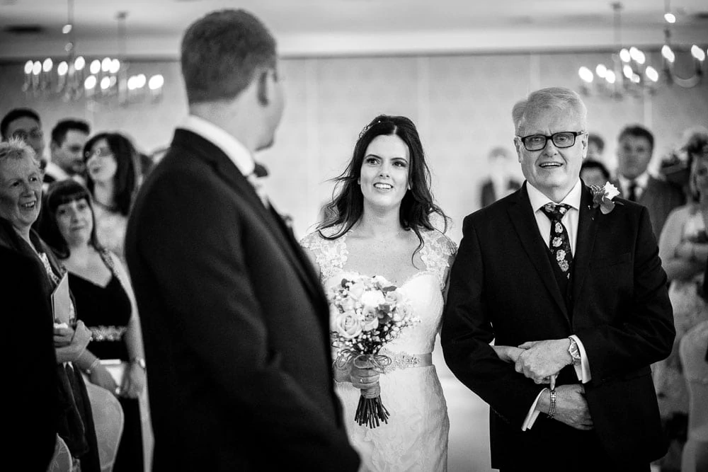 bride walking up the aisle at mottram hall