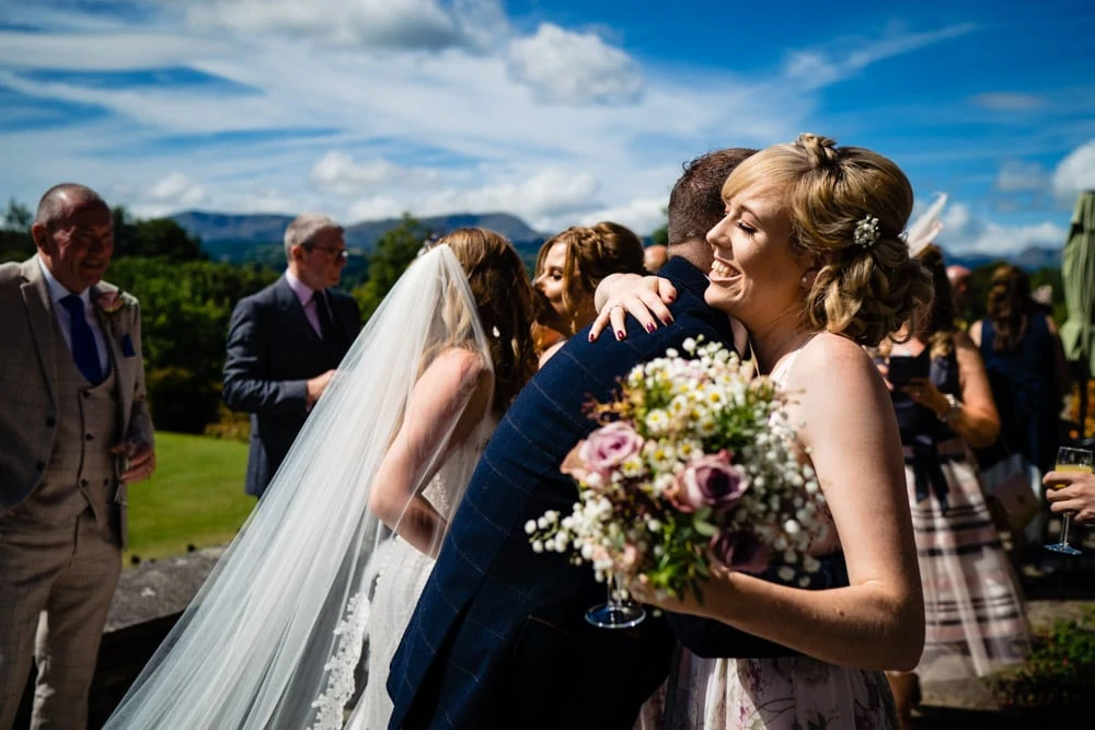 groom getting a hug