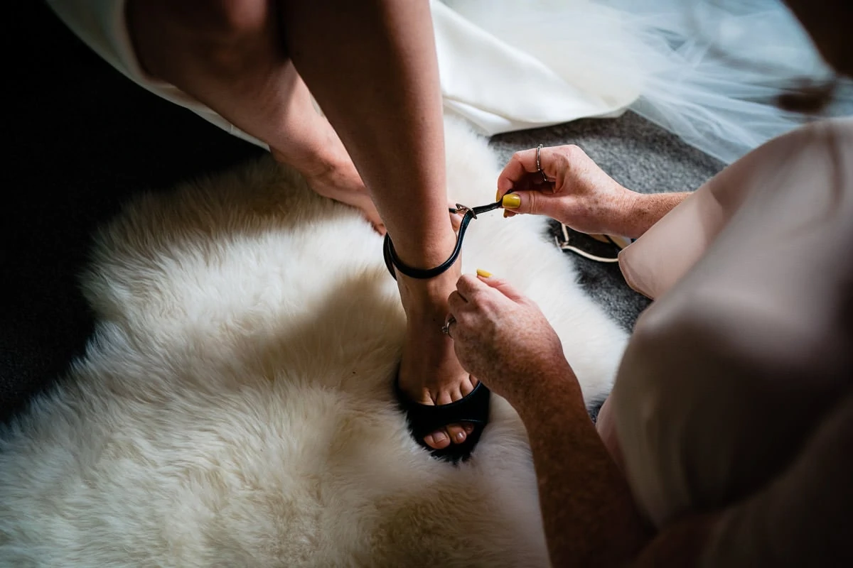 bride putting her Jimmy Choo's on