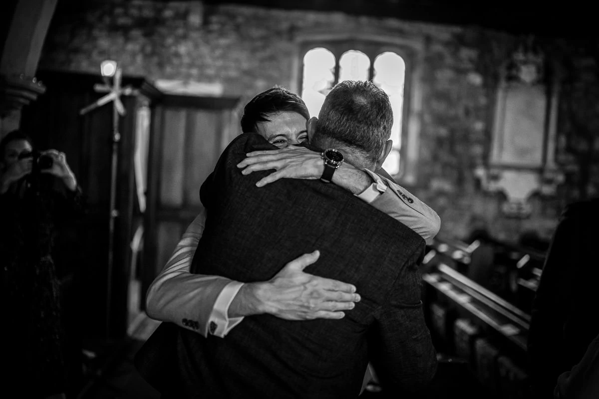 groom hugging guest