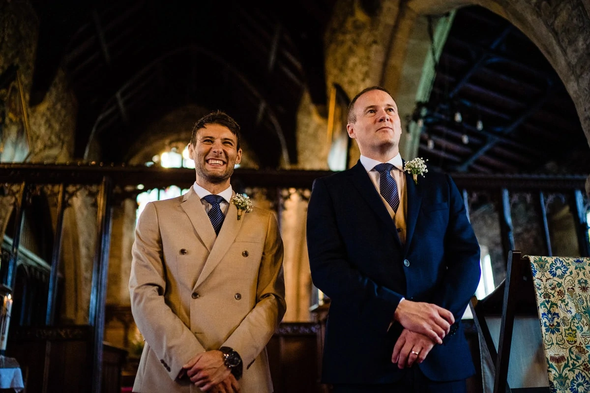 groom watching bride walk up the aisle