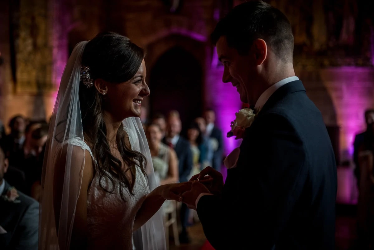 exchange of wedding rings at peckforton castle wedding