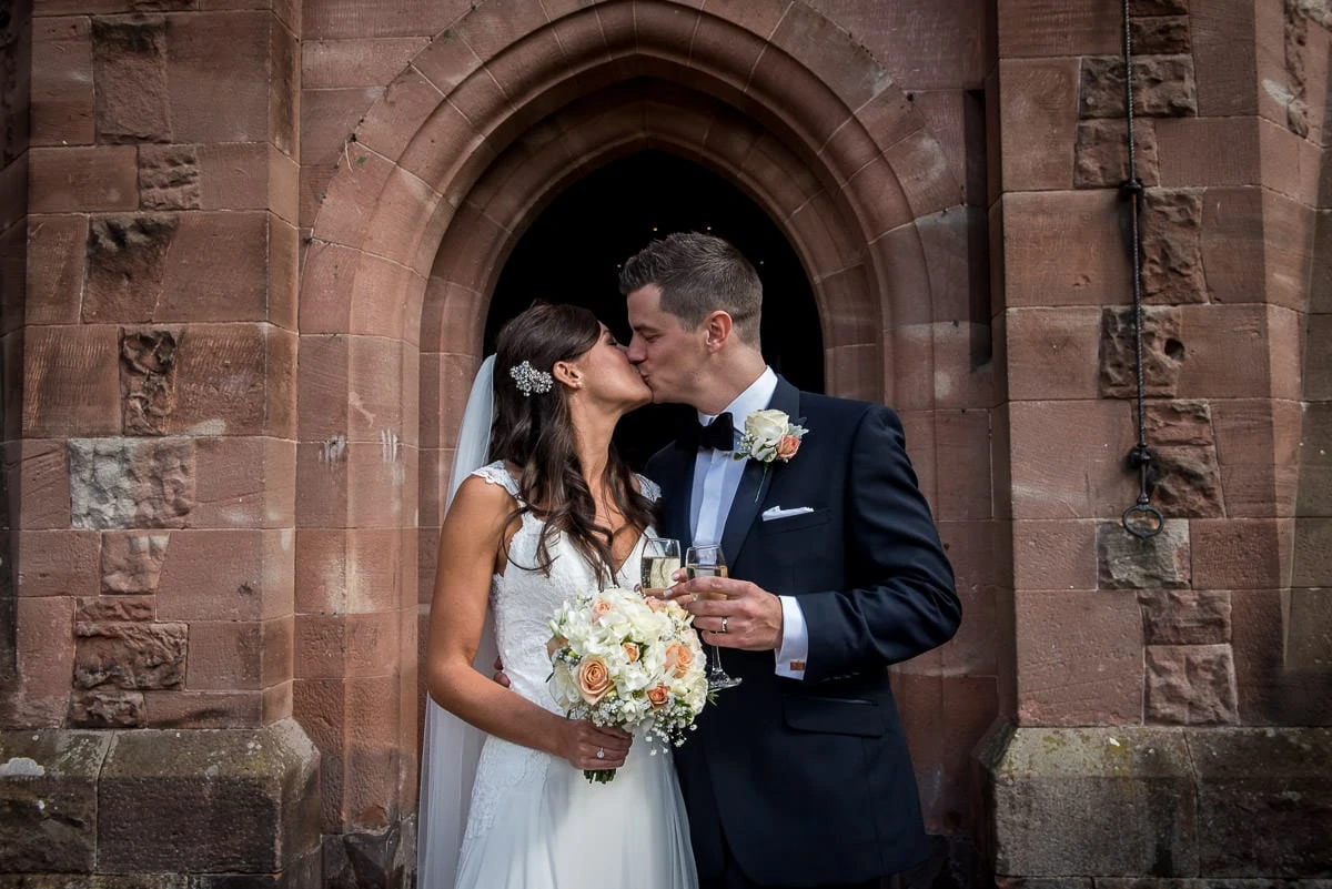 wedding kiss at peckforton castle