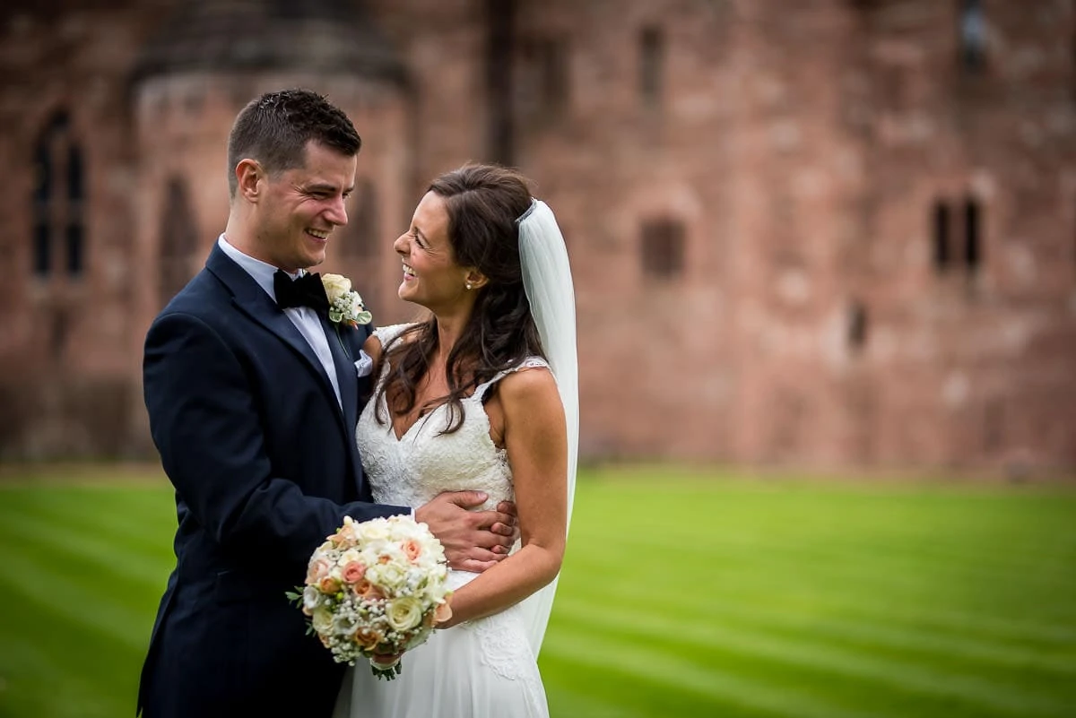 bride and groom at peckforton castle wedding in courtyard