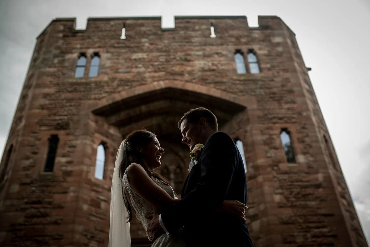 bride and groom outside peckforton castle