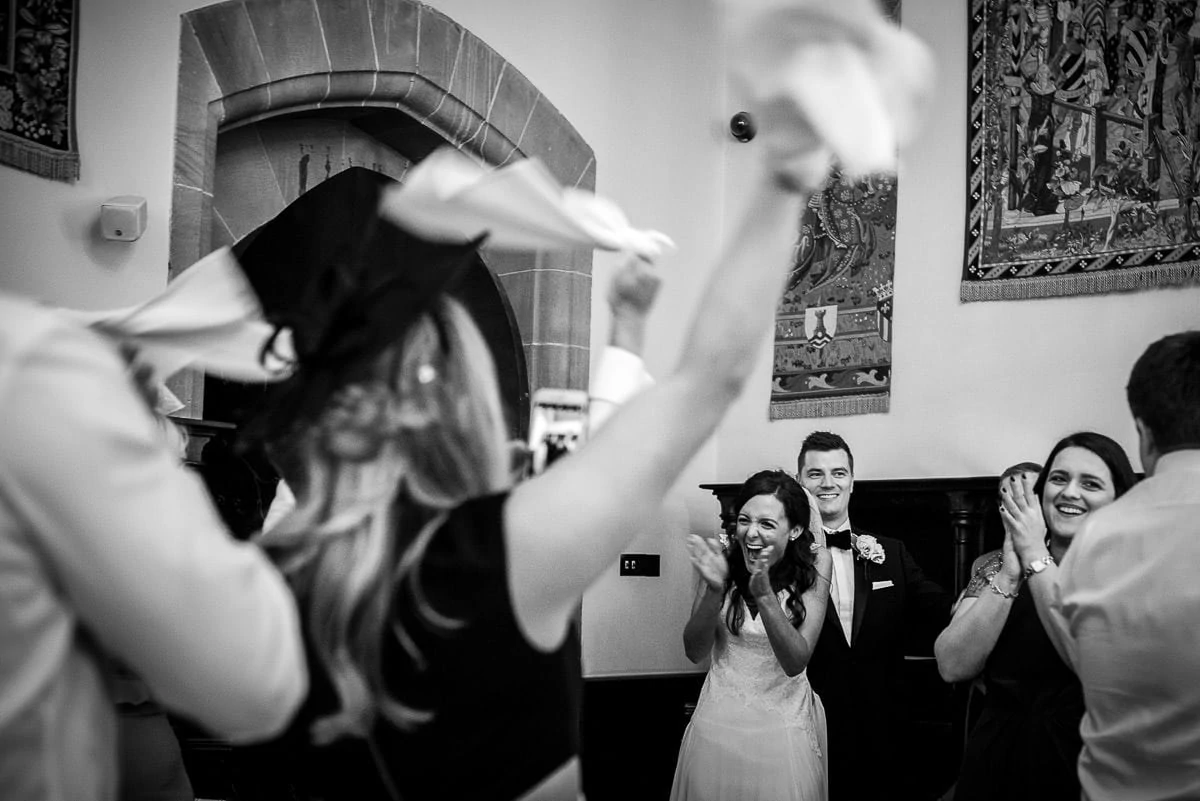 cheering wedding guests at peckforton castle
