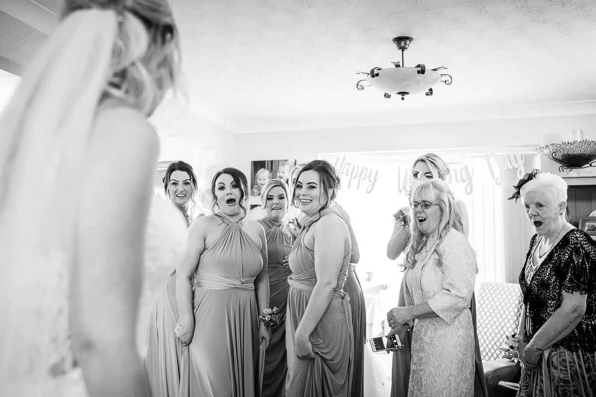 bridesmaid seeing bride in her dress
