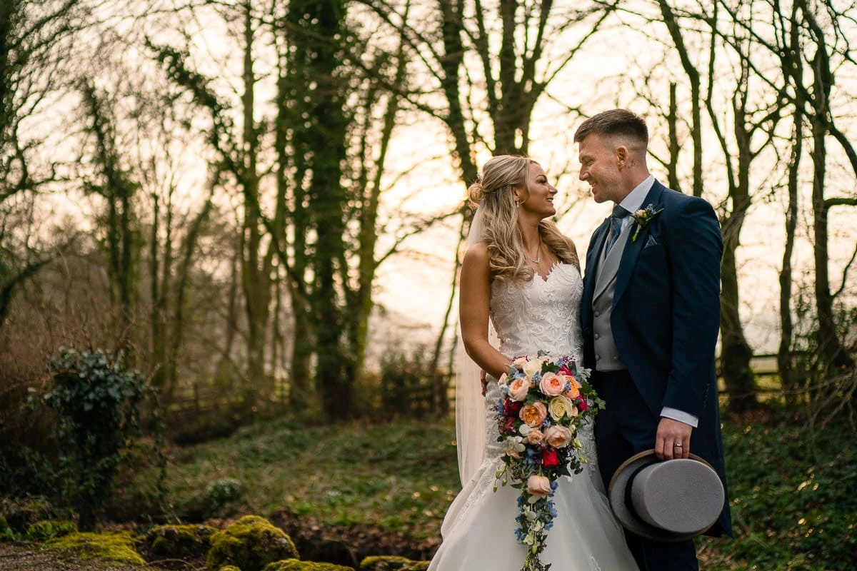bride and groom outside mitton hall