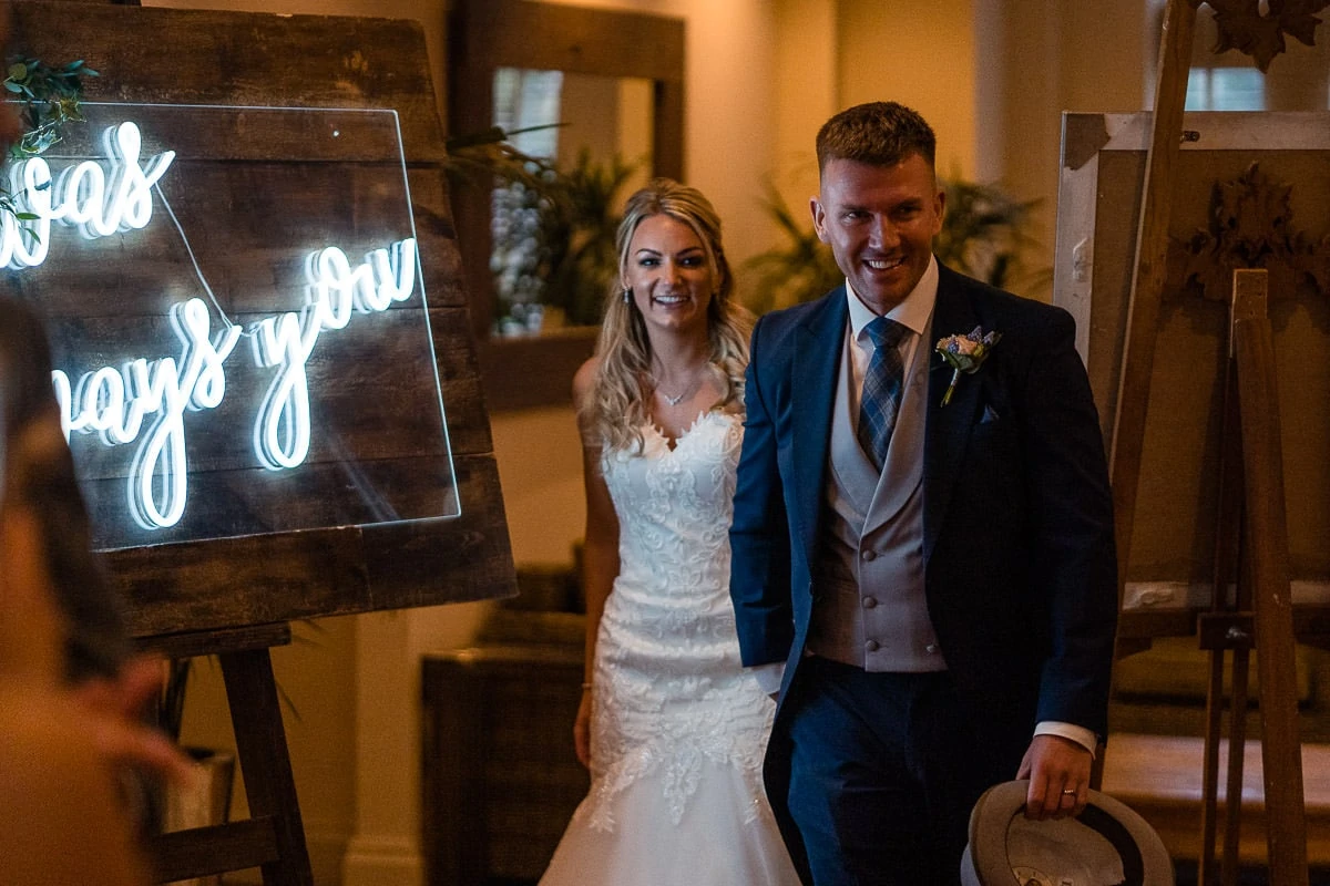 wedding couple walking into mitton hall