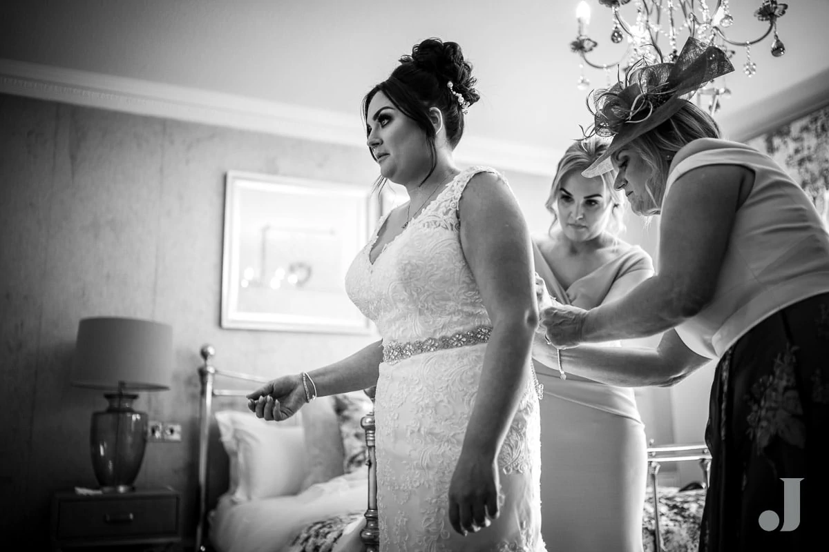 bride getting into her say yes to the dress wedding dress