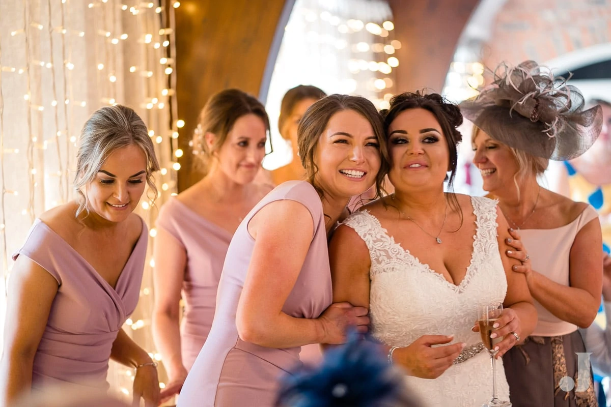 bridesmaid hugging the bride