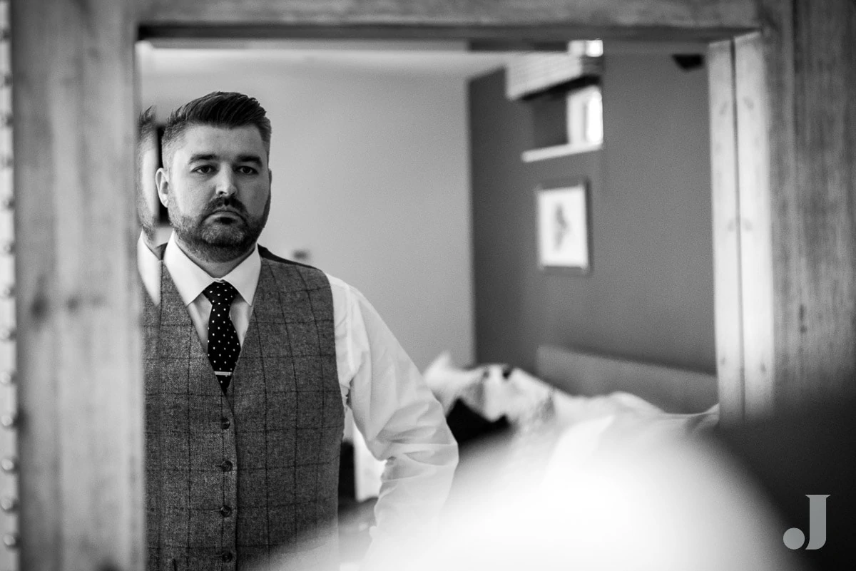 groom in a mirror at Colshaw Hall