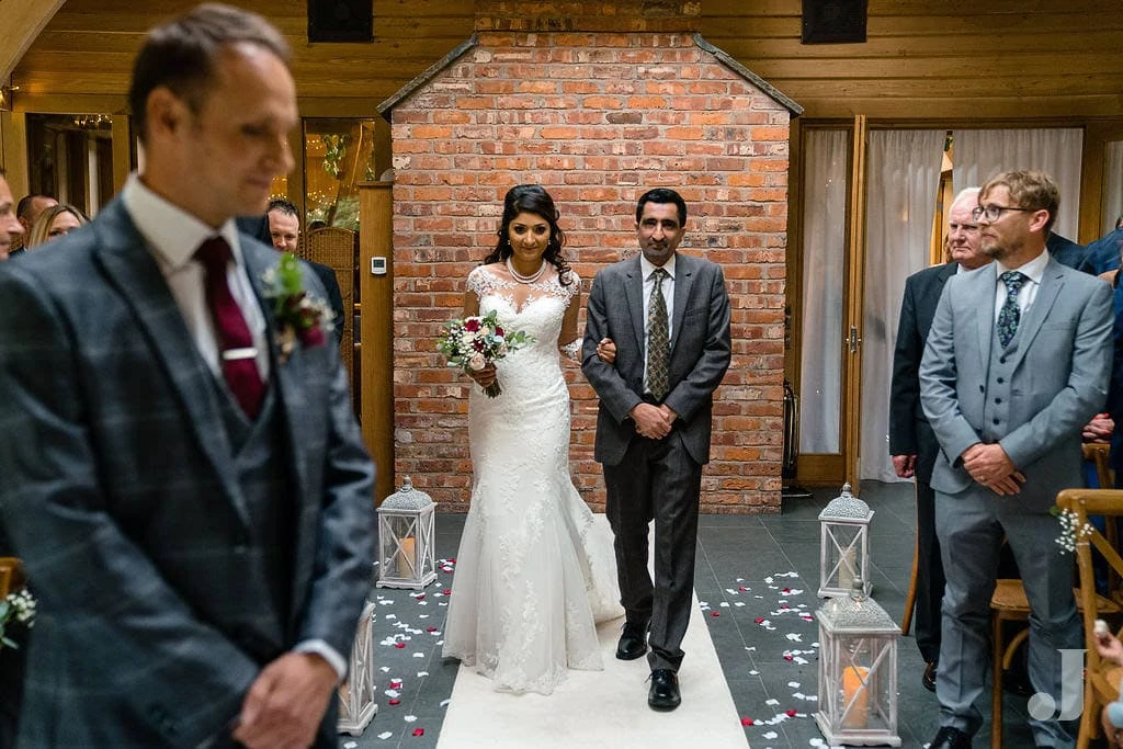 bride walking up the aisle at oak tree of peover