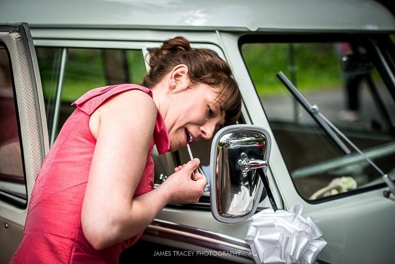 bridesmaid doing her make up in camper van window