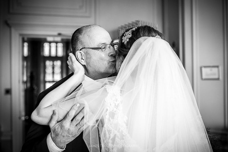 father of the bride kissing his daughter