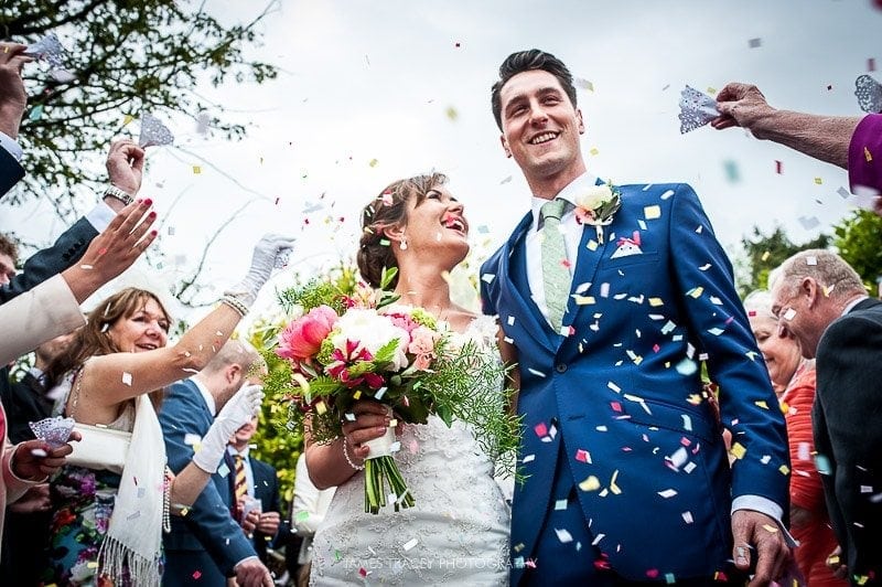 bride and groom covered in confetti