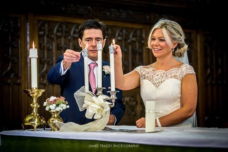 bride and groom lighting candles