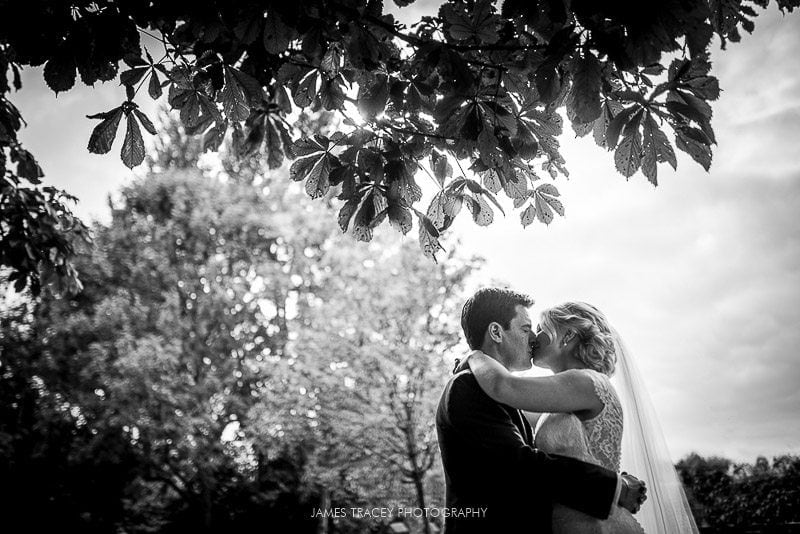 bride and groom kissing in fletcher moss park